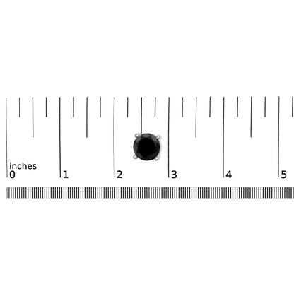 Close-up of a single white metal earring with a round black gemstone in a 4-prong setting, placed on a ruler for size reference, shot from above.
