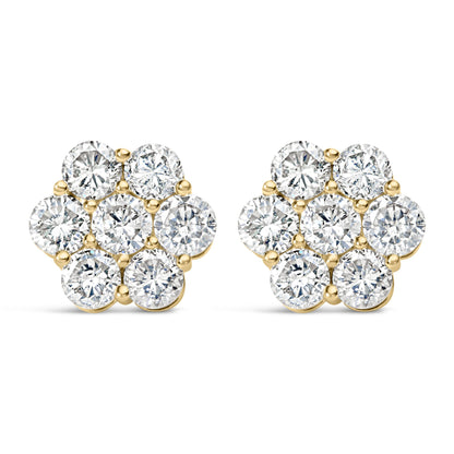 Front angle view of a pair of yellow metal earrings shaped like flowers, each featuring cluster of round white gemstones in prong settings.