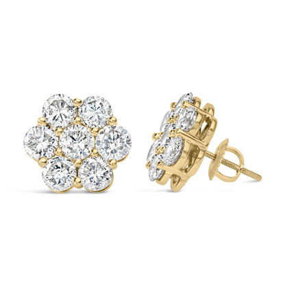 Pair of yellow metal stud earrings with round white gemstones in prong settings, shown from front and side angles.