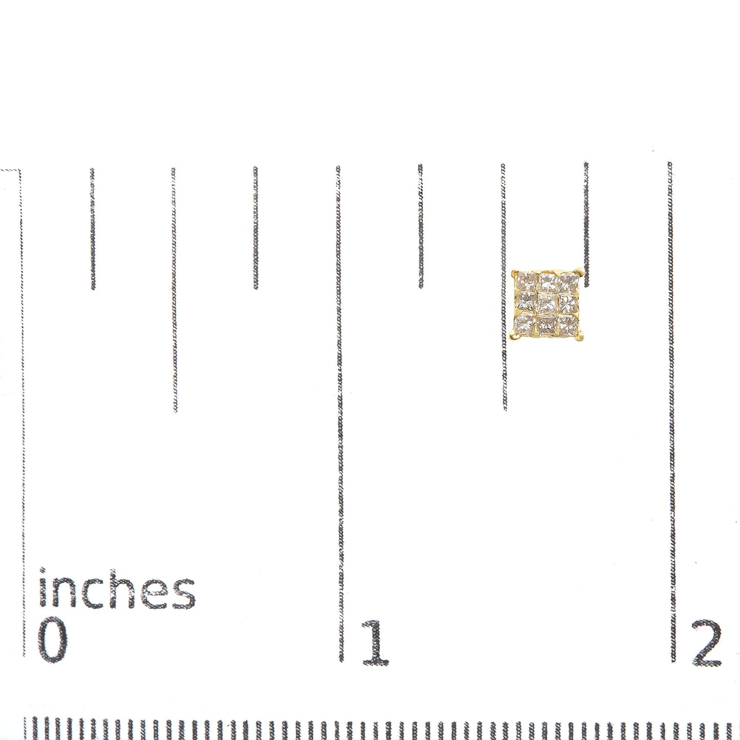 Close-up front view of a yellow metal stud earring with a square cluster of white princess-shaped gemstones in an invisible setting, placed on a ruler for size reference.
