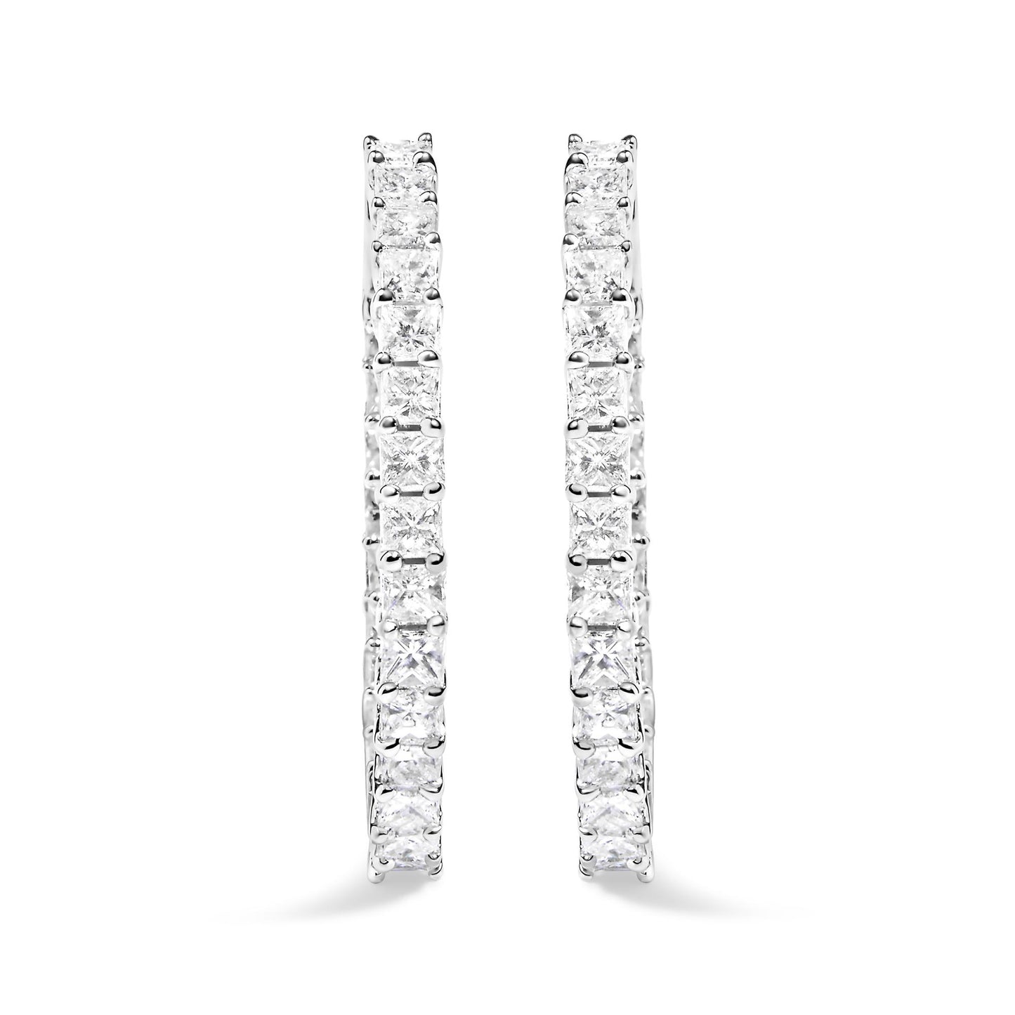 Close-up front view of white metal hoop earrings set with two rows of princess-shaped white gemstones in shared prong settings.