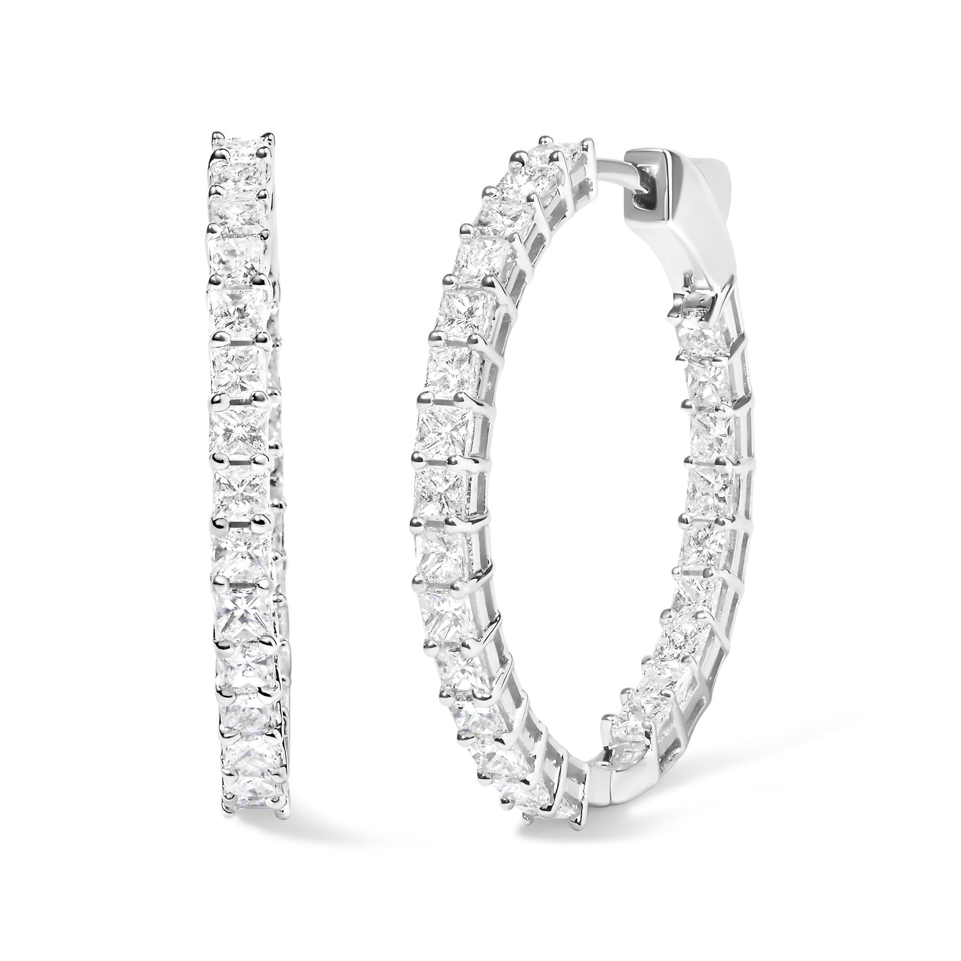 Close-up front and side view of a pair of white hoop earrings set with multiple white princess-shaped gemstones in shared prong settings.