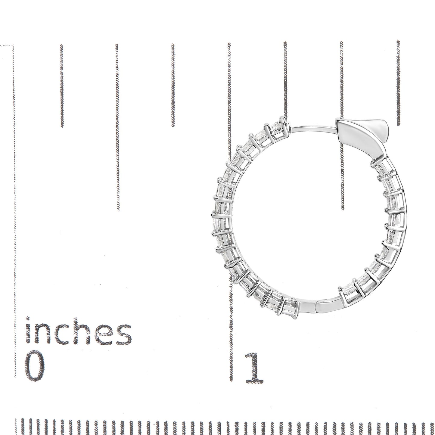 Close-up front angle of a white metal hoop earring with shared prong settings holding white princess shape gemstones, placed on a ruler for size reference.