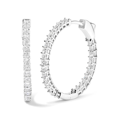 Pair of white metal hoop earrings set with multiple princess-shaped white gemstones in shared prong setting, shown from front and side angles.