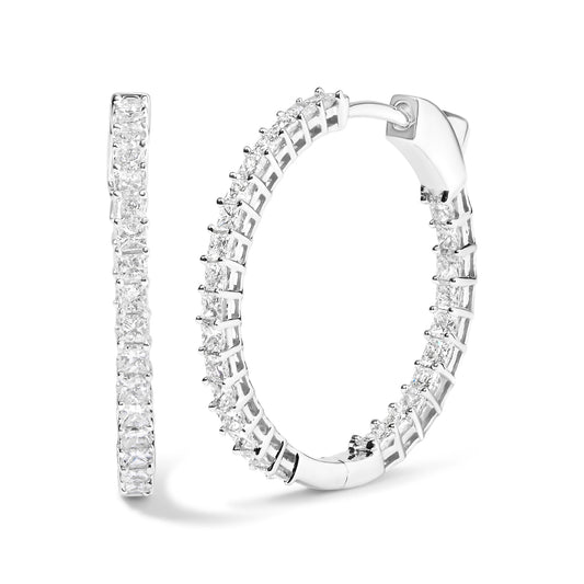 Pair of white metal hoop earrings set with multiple princess-shaped white gemstones in shared prong setting, shown from front and side angles.