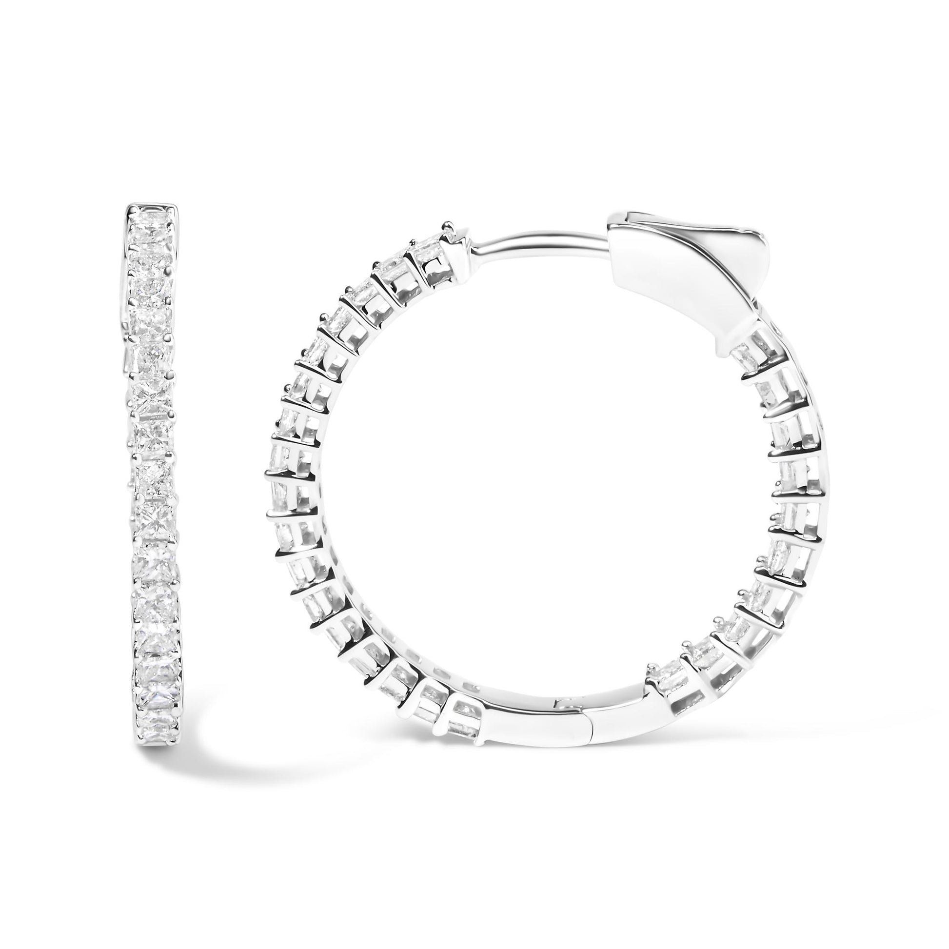 Close-up front and side view of white metal hoop earrings set with multiple princess shape white gemstones in shared prong settings.