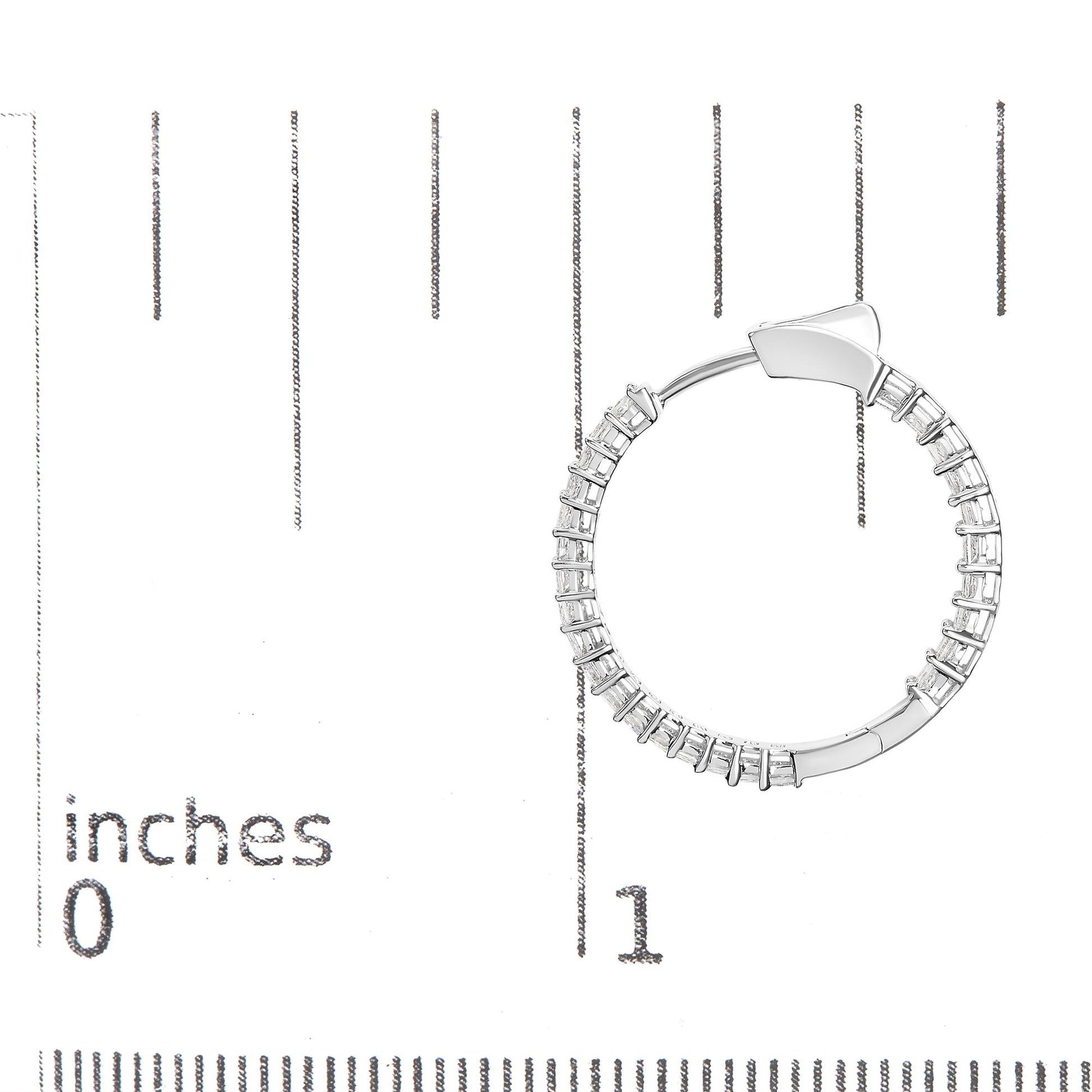 White metal hoop earring set with princess shape white gemstones in shared prong setting, photographed flat on a ruler for size reference.