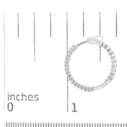 White metal hoop earring set with princess shape white gemstones in shared prong setting, photographed flat on a ruler for size reference.