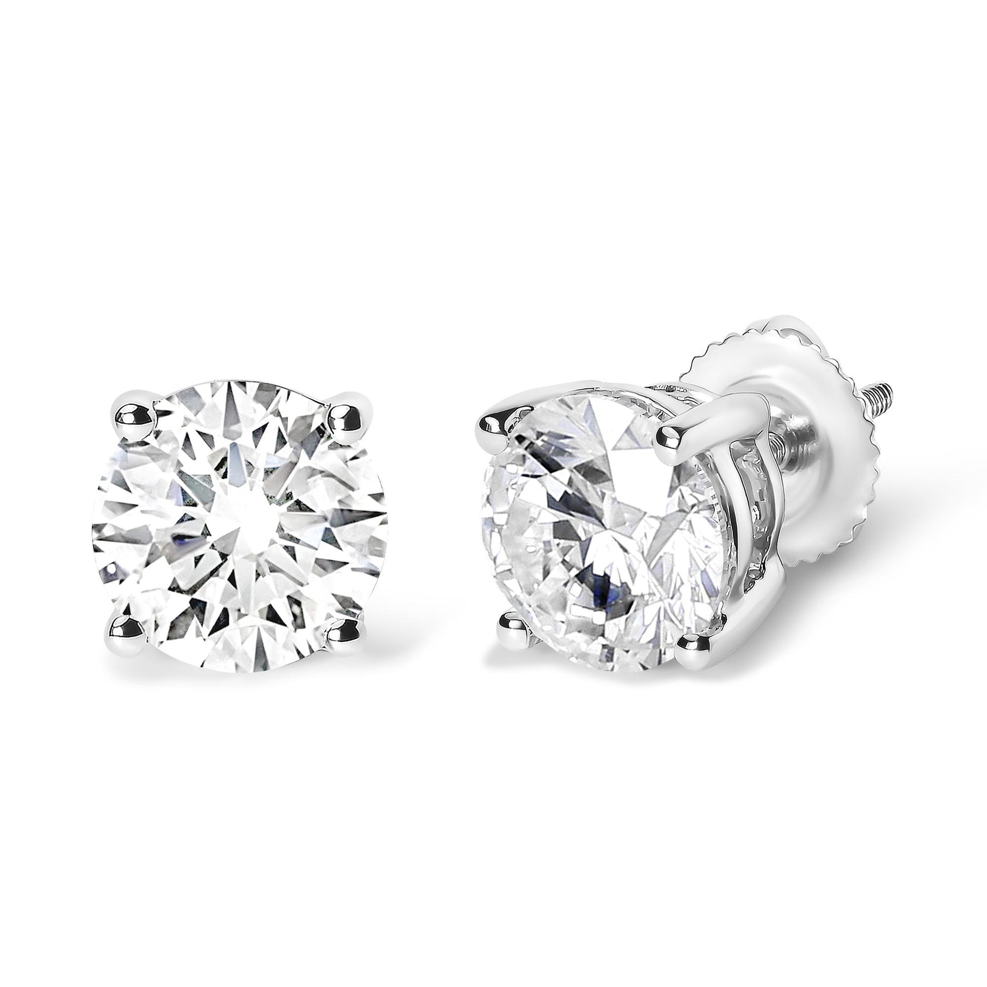 Pair of white metal stud earrings with round white gemstones in four-prong settings, shown from a front and angled side view.