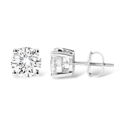 Pair of white metal stud earrings with round white gemstones in 4-prong settings, shown from front and side angles on a white background.