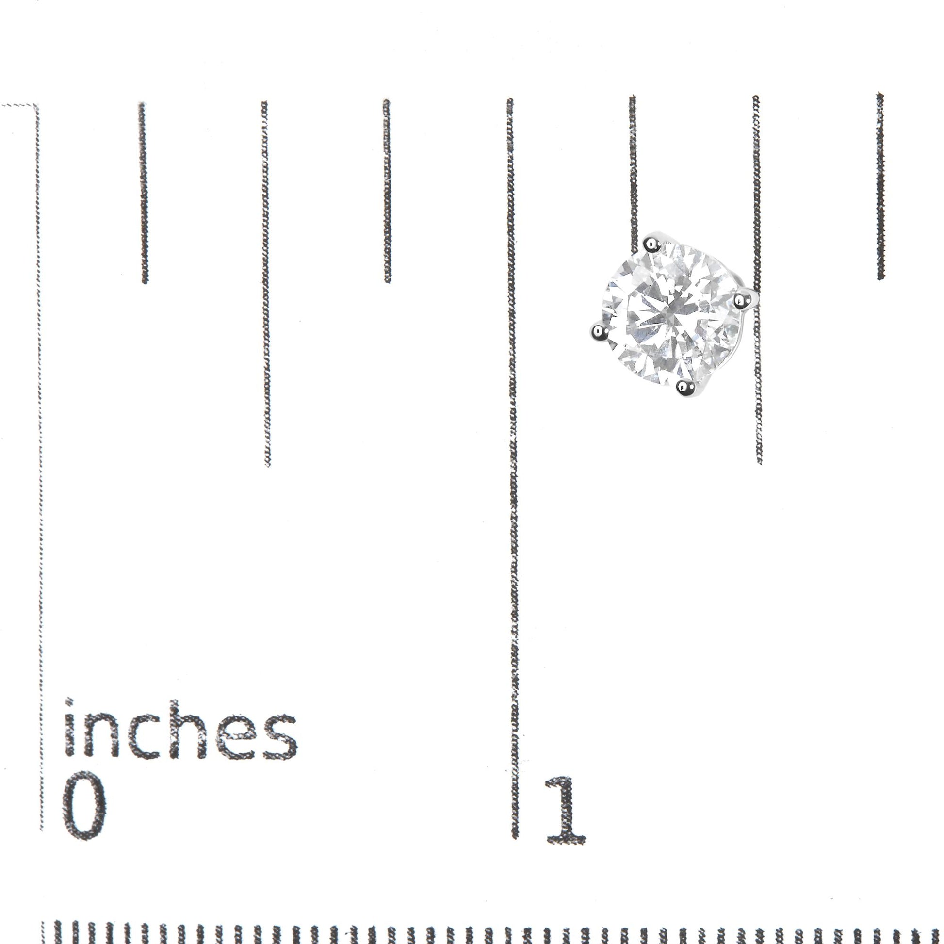 Close-up front view of a single white metal earring with a round white gemstone in a 4-prong setting, placed on a ruler for size reference.