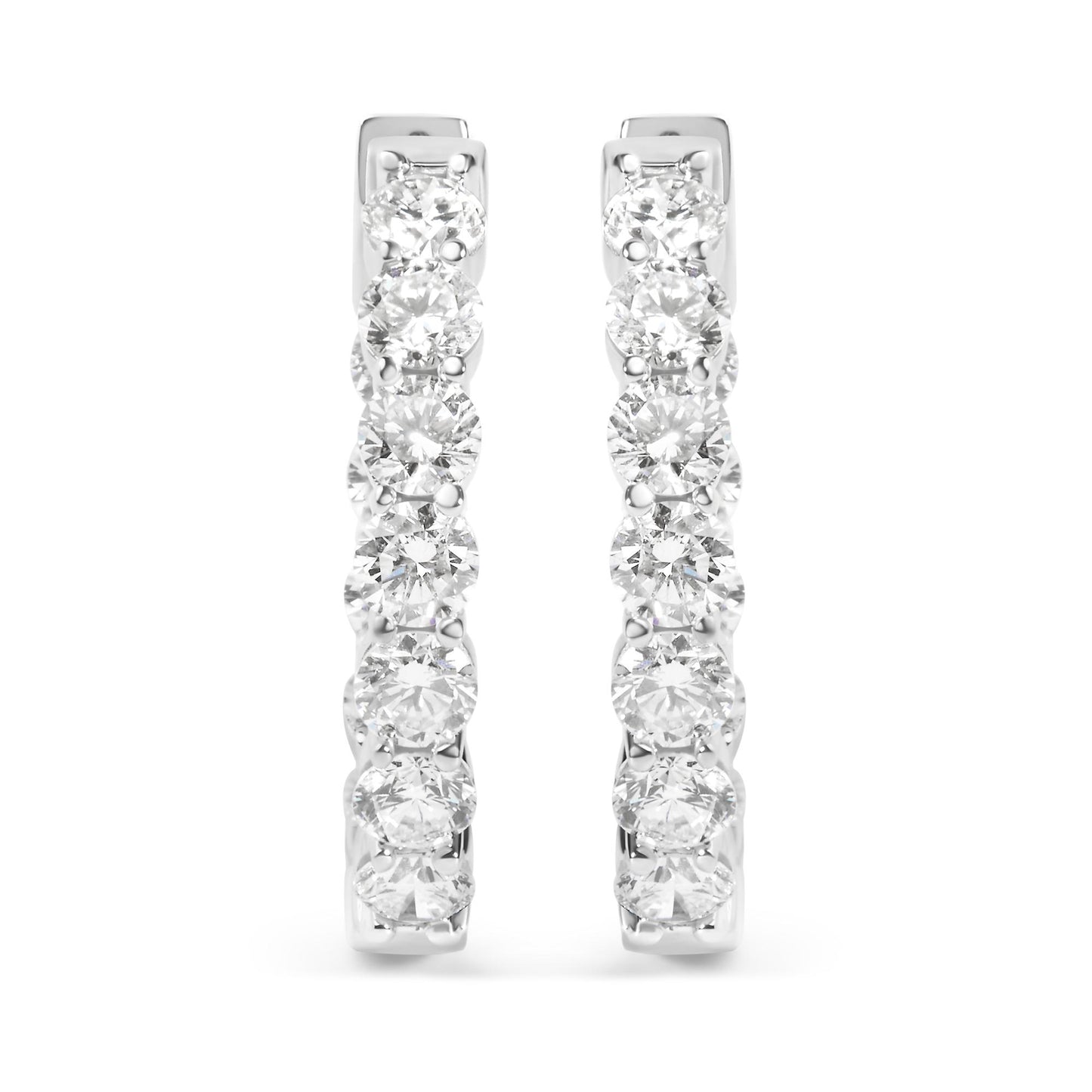 Front view of a pair of white metal hoop earrings set with multiple round white gemstones in a shared prong setting.