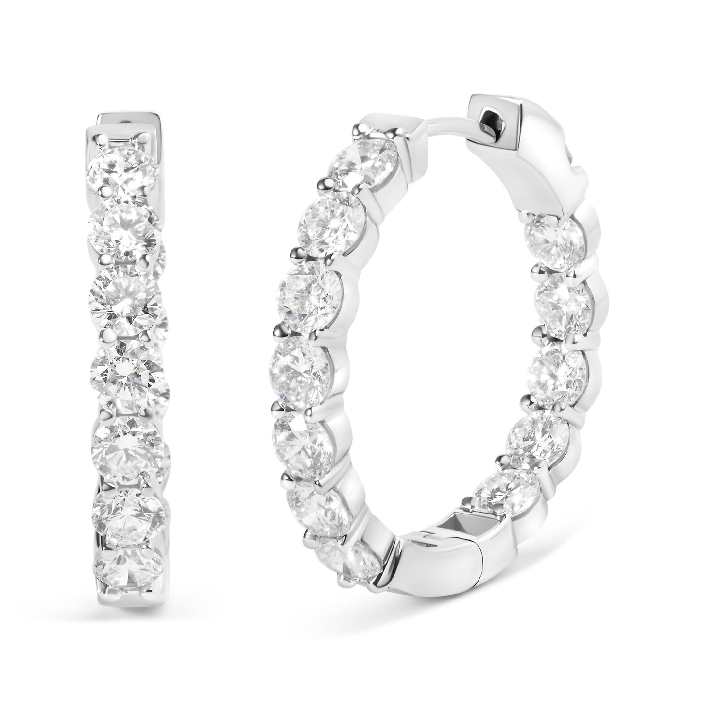 Pair of white metal hoop earrings with round white gemstones set along the outer edge in shared prong settings, shown at a front and angled side view on a white background.