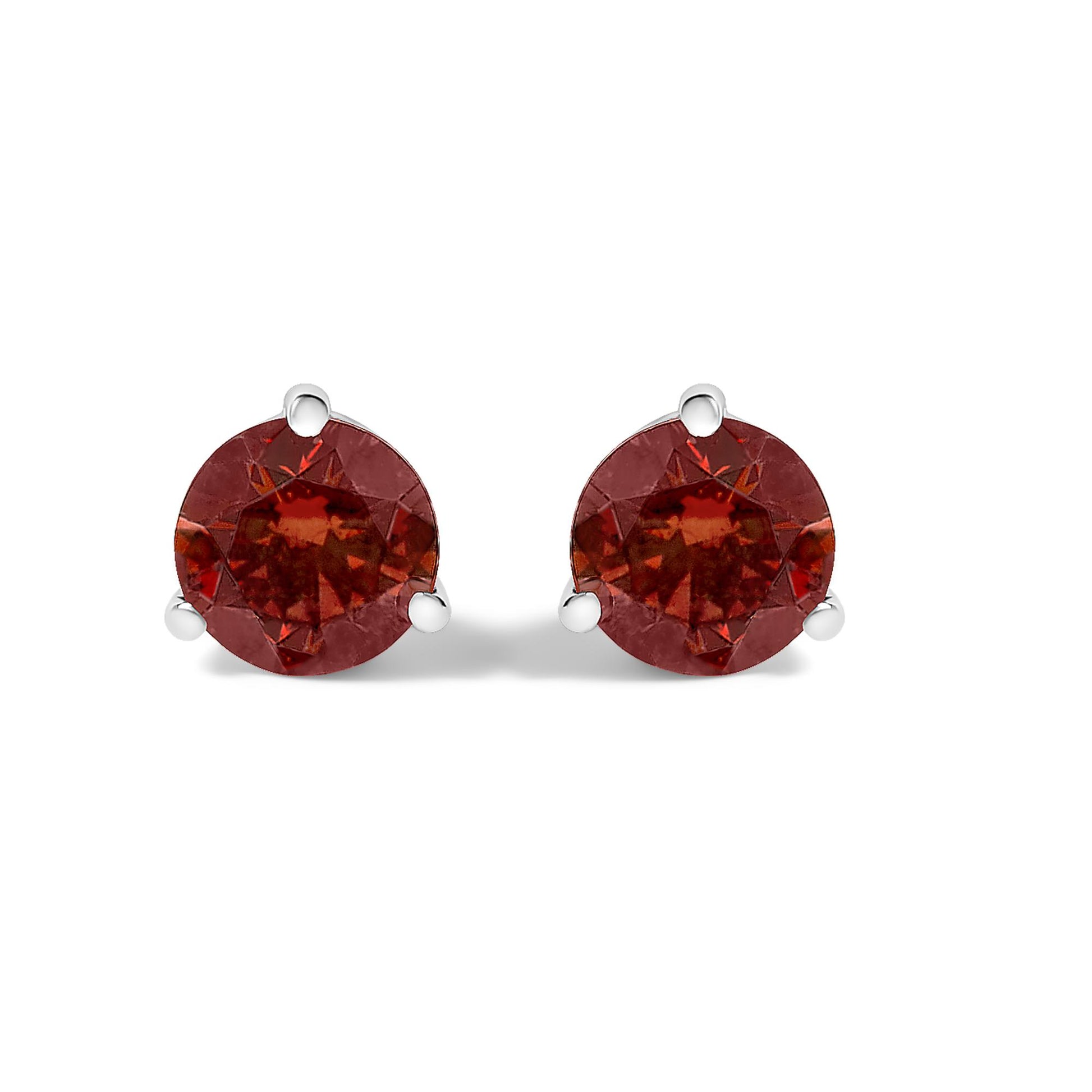 Pair of white metal stud earrings with round red gemstones in 3-prong settings, shown from the front on a white background.