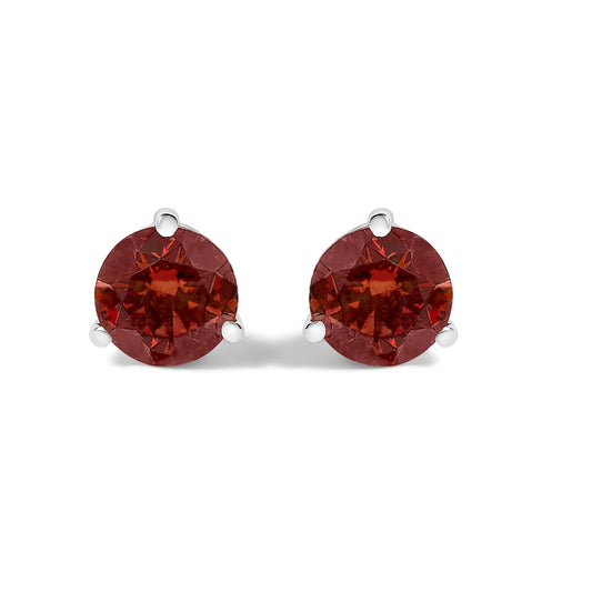 Pair of white metal stud earrings with round red gemstones in 3-prong settings, shown from the front on a white background.