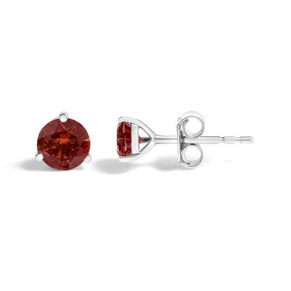 Pair of white metal stud earrings with round red gemstones in three-prong settings, shown at front and side angles on a white background.