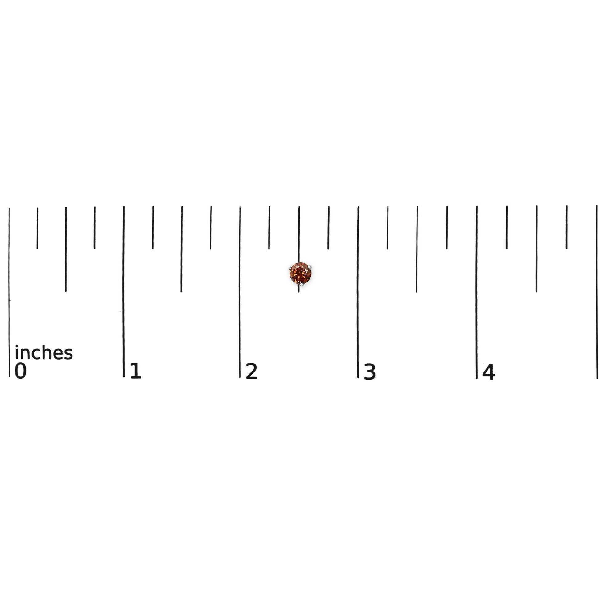 White metal stud earring with round red gemstone in 3-prong setting, shown on a ruler scale from top angle.