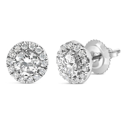 Close-up front and side angled view of white metal stud earrings featuring a central round white gemstone surrounded by a halo of smaller round white gemstones in prong settings.