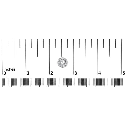 White metal round earrings with prong-set white gemstones in a cluster design, shown on a ruler for size reference, top-down angle.