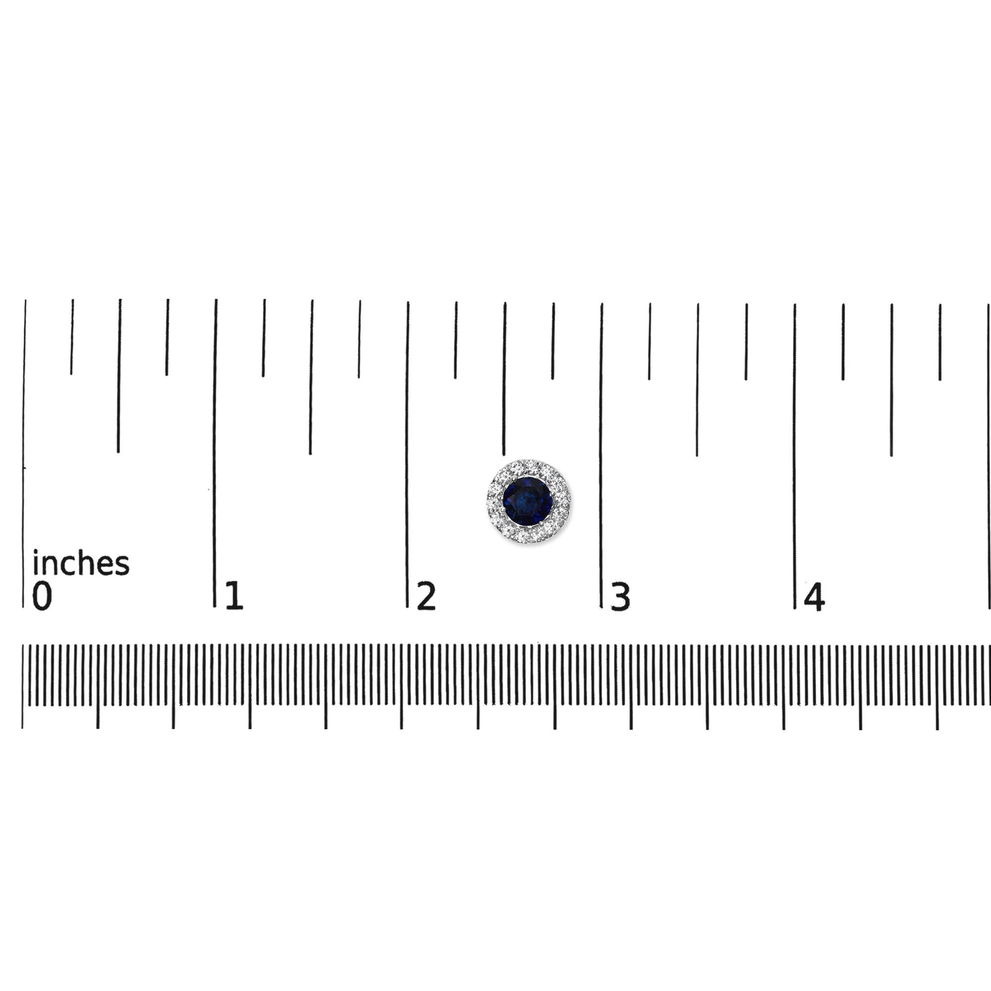 White round stud earring with a central blue gemstone surrounded by smaller white gemstones, shown on a ruler scale from a top-down angle.