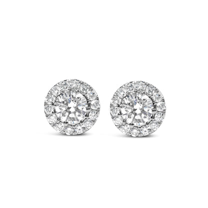 Front view of white metal round stud earrings with a large central white gemstone surrounded by a halo of smaller white gemstones.