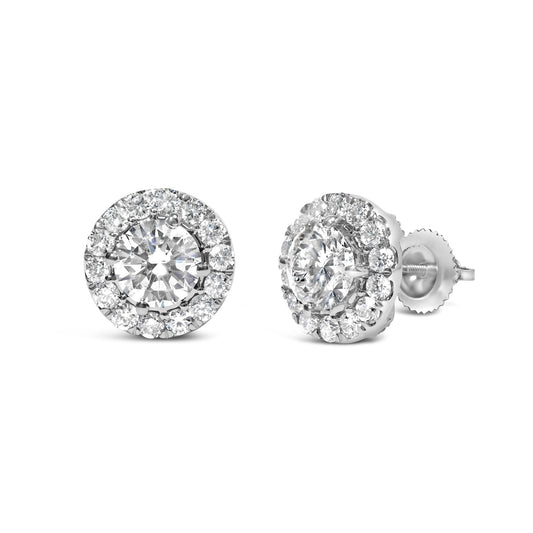 Pair of white metal stud earrings with round white gemstones in prong settings, shown in a front and side angle view.