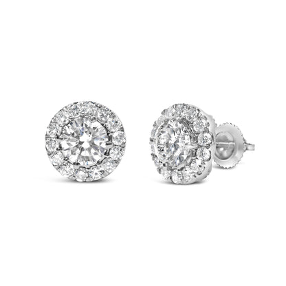Pair of white metal stud earrings with round white gemstones in prong settings, shown in a front and side angle view.
