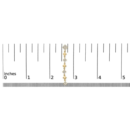 Yellow metal dangling earring with multiple white round gemstones in prong settings, shown on a ruler for size reference, front-facing angle.