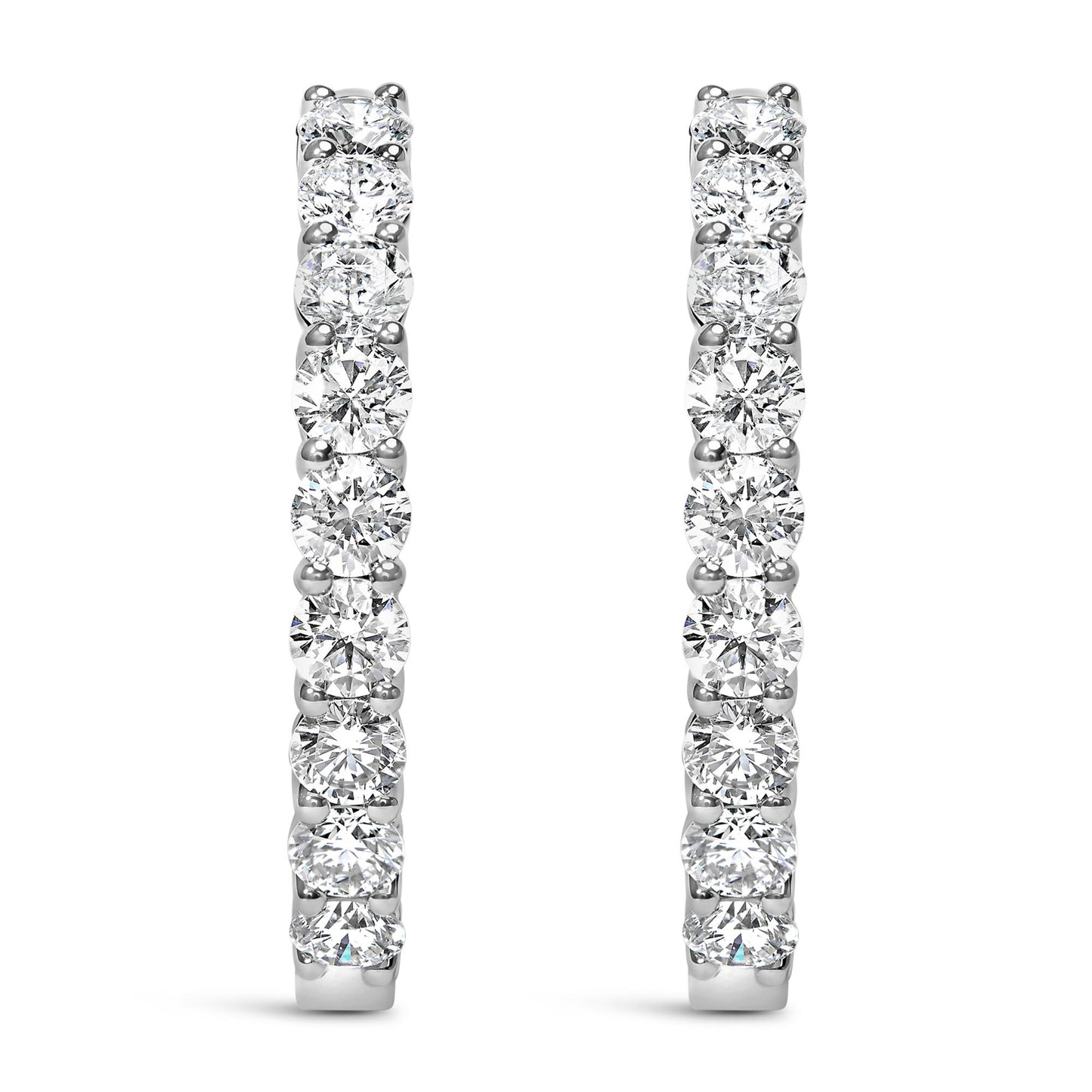 Front view of white metal hoop earrings set with round white gemstones in shared prong settings.