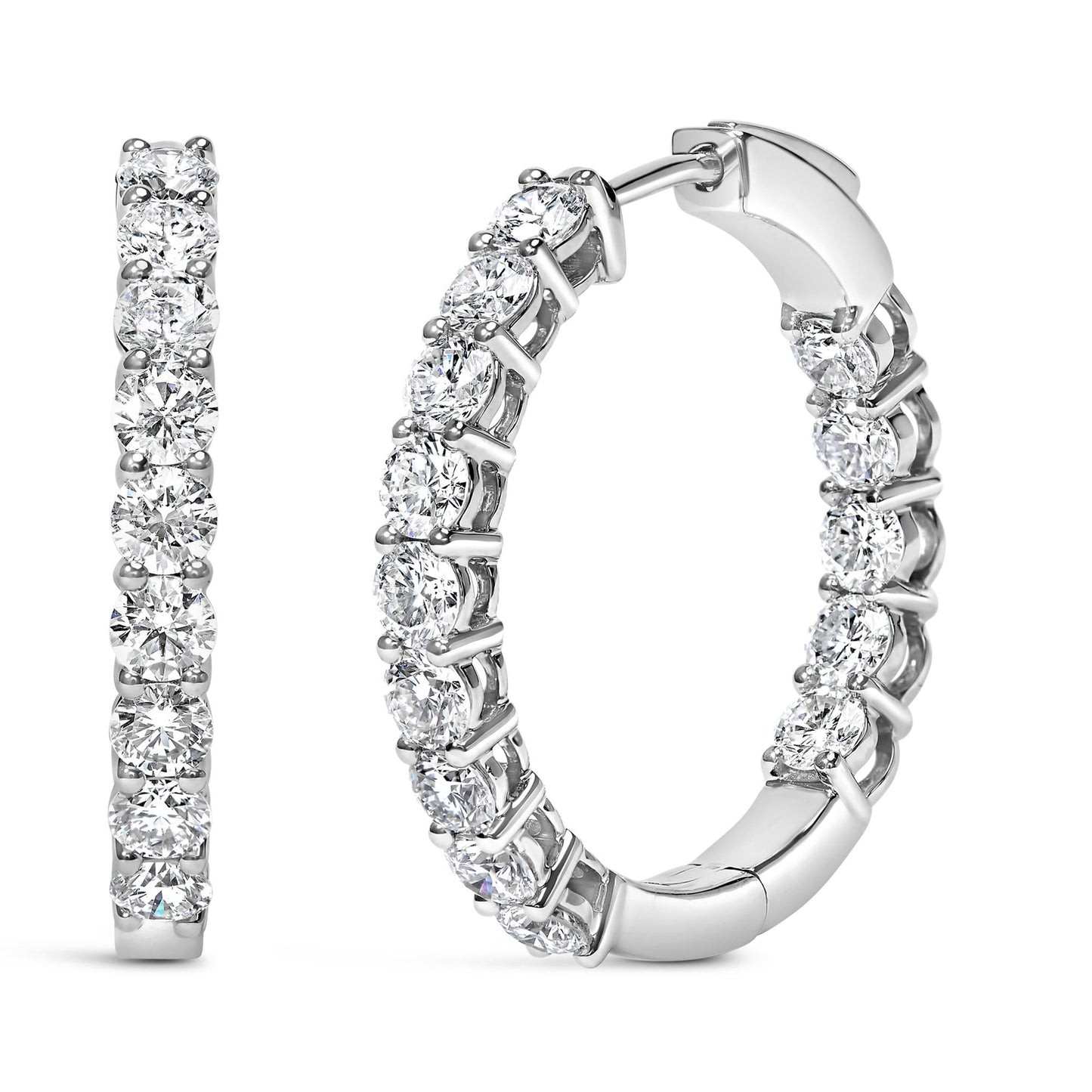 Close-up front and side view of white metal hoop earrings with round white gemstones in shared prong settings.