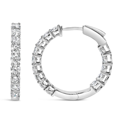 Front and side views of a pair of white metal hoop earrings with round white gemstones set in shared prong settings, shown on a white background.