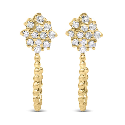 Front-facing view of a pair of yellow metal earrings featuring cluster arrangements of prong-set round white gemstones at the top and a textured hoop design below.
