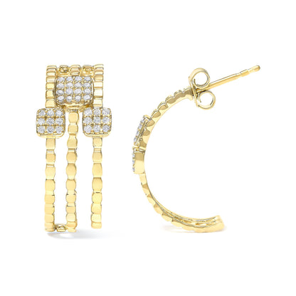 Front and side view of yellow metal earrings with triple band design and three square clusters of white gemstones in prong settings, shown against a white background.