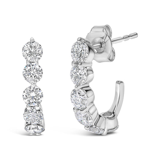 Pair of white metal hoop earrings with round white gemstones in prong settings, shown from front and side angles.