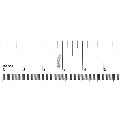 Close-up front view of a white metal earring with multiple round white gemstones in prong settings, placed on a ruler for size reference.