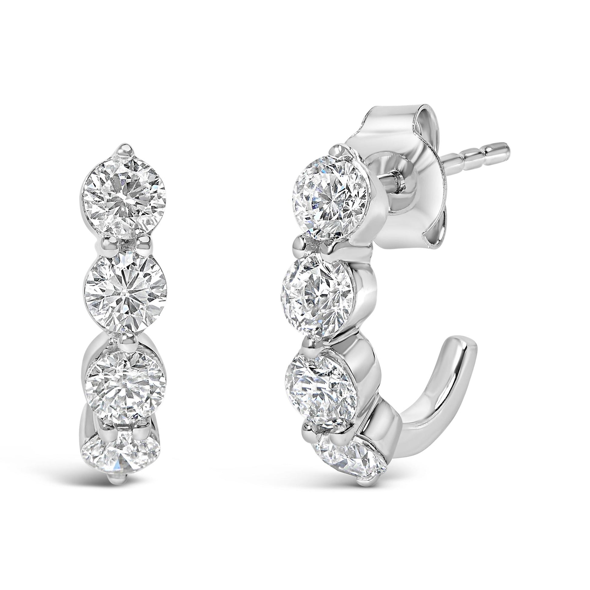 Front and side view of white metal earrings with multiple round white gemstones in prong settings, shown against a white background.