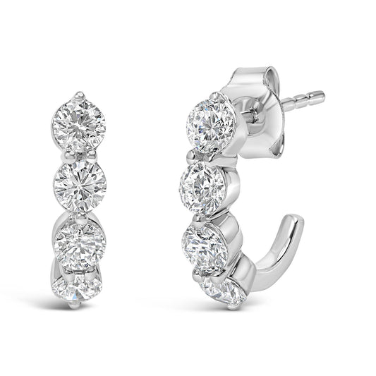 Front and side view of white metal earrings with multiple round white gemstones in prong settings, shown against a white background.