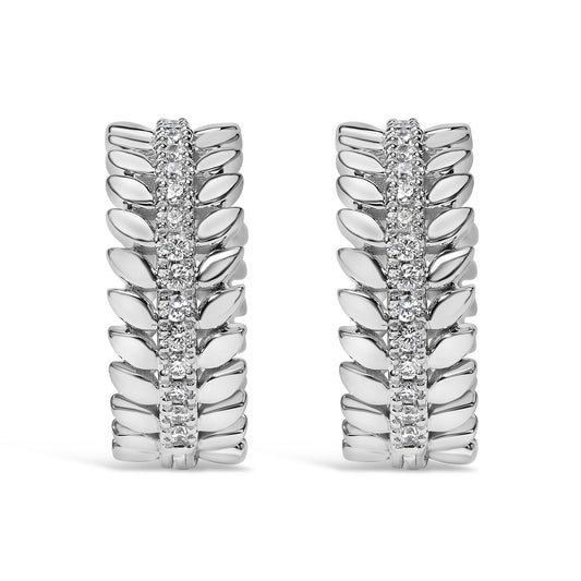Front-facing view of white metal hoop earrings with a central row of round white gemstones in prong settings, flanked by a leaf-like design on both sides.