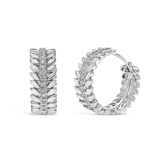 Pair of white metal hoop earrings with leaf-shaped details and a central row of prong-set round white gemstones, shown from front and side angles on a white background.