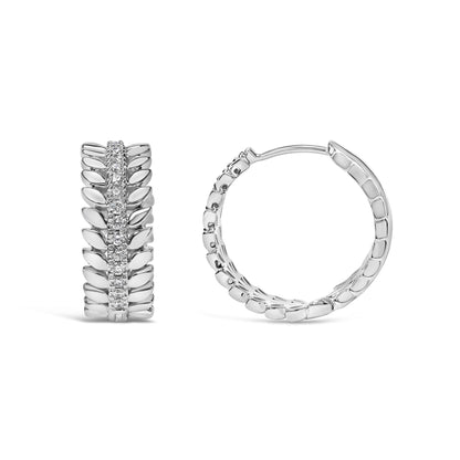 Front and side angled view of white metal hoop earrings with a row of round white gemstones in a prong setting along the center.