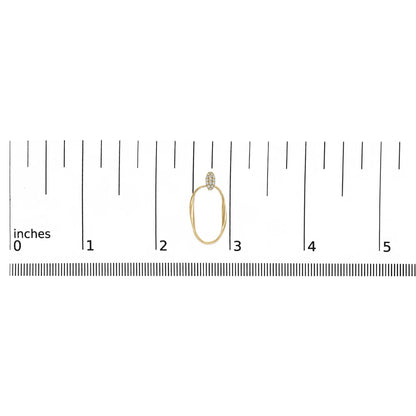 Single yellow metal earring with an oval-shaped hoop and a top section paved with small white gemstones, shown on a ruler for size reference, photographed from the front.