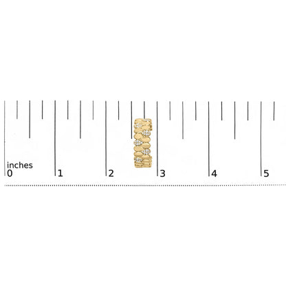 Close-up front view of a yellow metal earring with round white gemstones in prong and pave settings, placed vertically on a ruler for size reference.