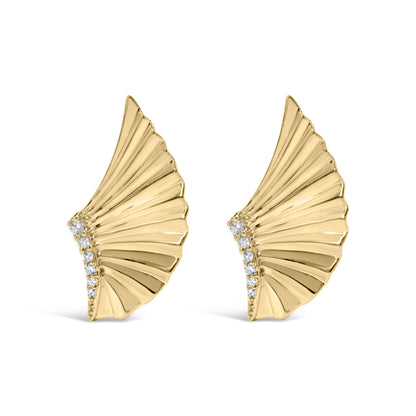Front angle view of yellow metal earrings shaped like fan blades with a curved row of small white round gemstones along one edge.