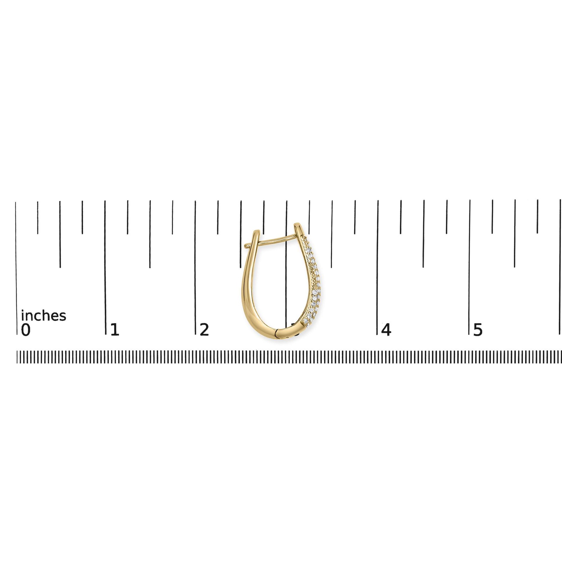 Yellow metal earring with pave white gemstones, shown in a front view on a ruler for size reference.