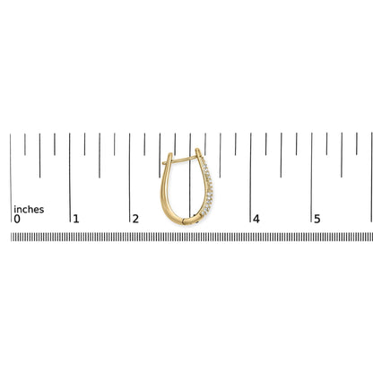 Yellow metal earring with pave white gemstones, shown in a front view on a ruler for size reference.