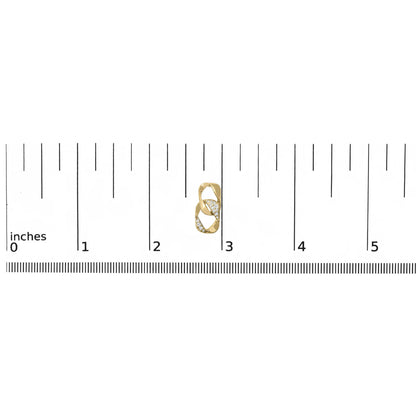 Close-up front view of a yellow metal earring with intertwined design featuring round white gemstones, placed on a ruler for size reference.