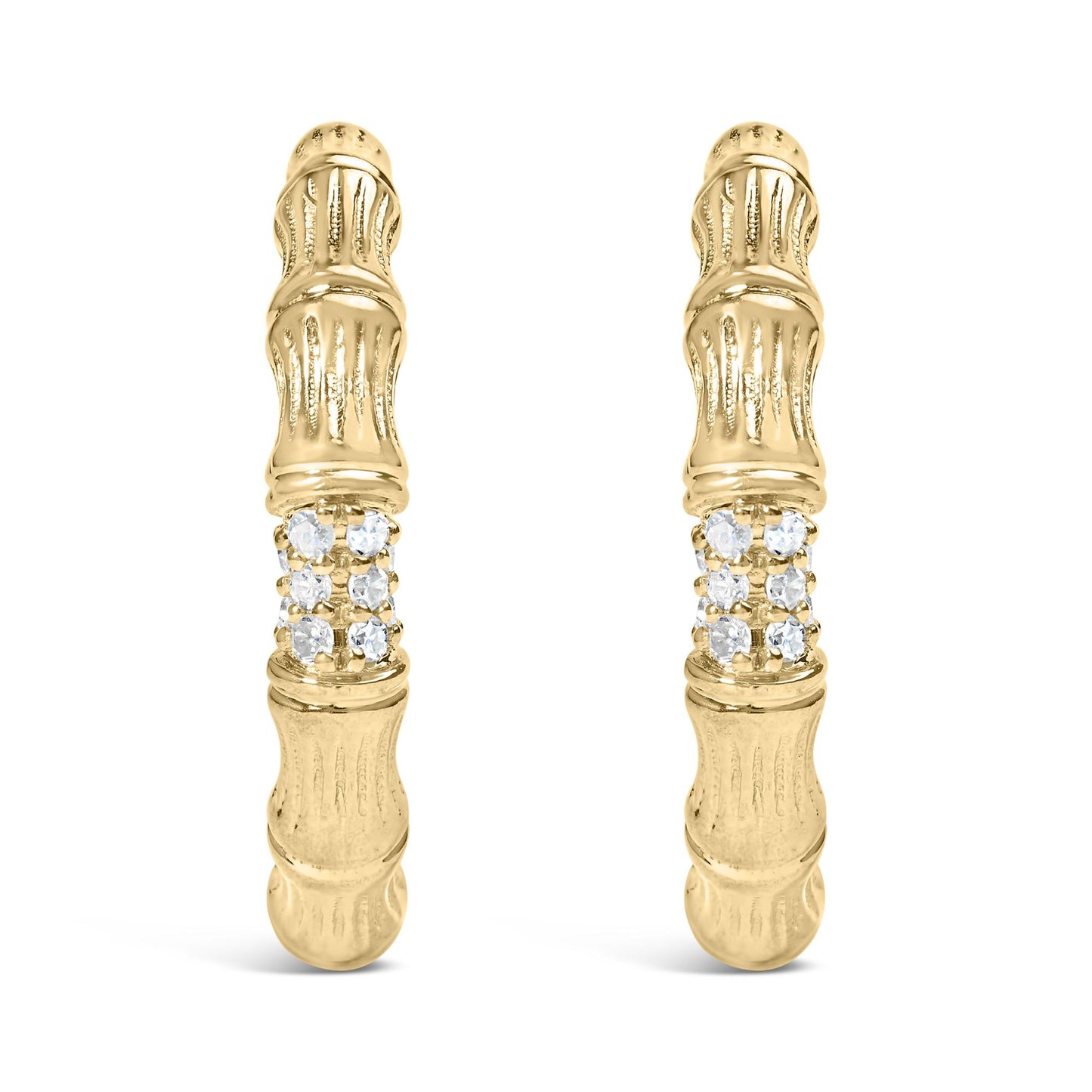 Front facing shot of a pair of yellow metal earrings with textured design and a cluster of round white gemstones in prong settings near the center.
