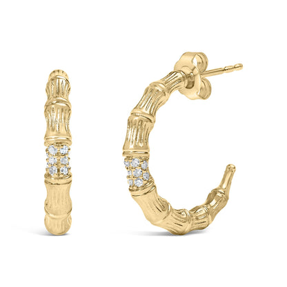 Pair of yellow metal hoop earrings with textured bamboo-like design and cluster of round white gemstones set in prongs, shown from front and side angles.
