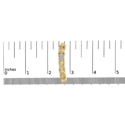 Single yellow metal earring with a row of round white gemstones, shown from the top on a ruler for size reference.