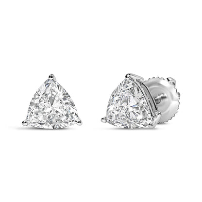 Pair of white metal stud earrings with trillion-shaped white gemstones in three-prong settings, shown from front and side angles.